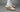 adidas Handball Spezial FIFA World Cup 2026 Mexico sneakers worn on foot with white adidas crew socks, featuring an off-white suede upper, green and red stripes, gold Spezial branding, and gum soles in a studio lifestyle campaign photo.