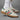 adidas Handball Spezial FIFA World Cup 2026 Mexico sneakers worn on foot with white adidas crew socks, featuring an off-white suede upper, green and red stripes, gold Spezial branding, and gum soles in a studio lifestyle campaign photo.