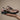 ASICS Gel-Nimbus 10.1 Black Rose Gold sneaker held in hand against neutral background, side profile display