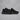 New Balance black chunky sneakers pair angled view on grey textured studio background with soft shadow